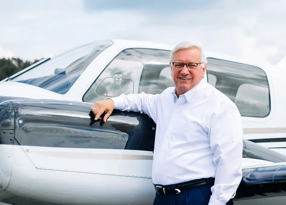 Randy Jones in front of airplane